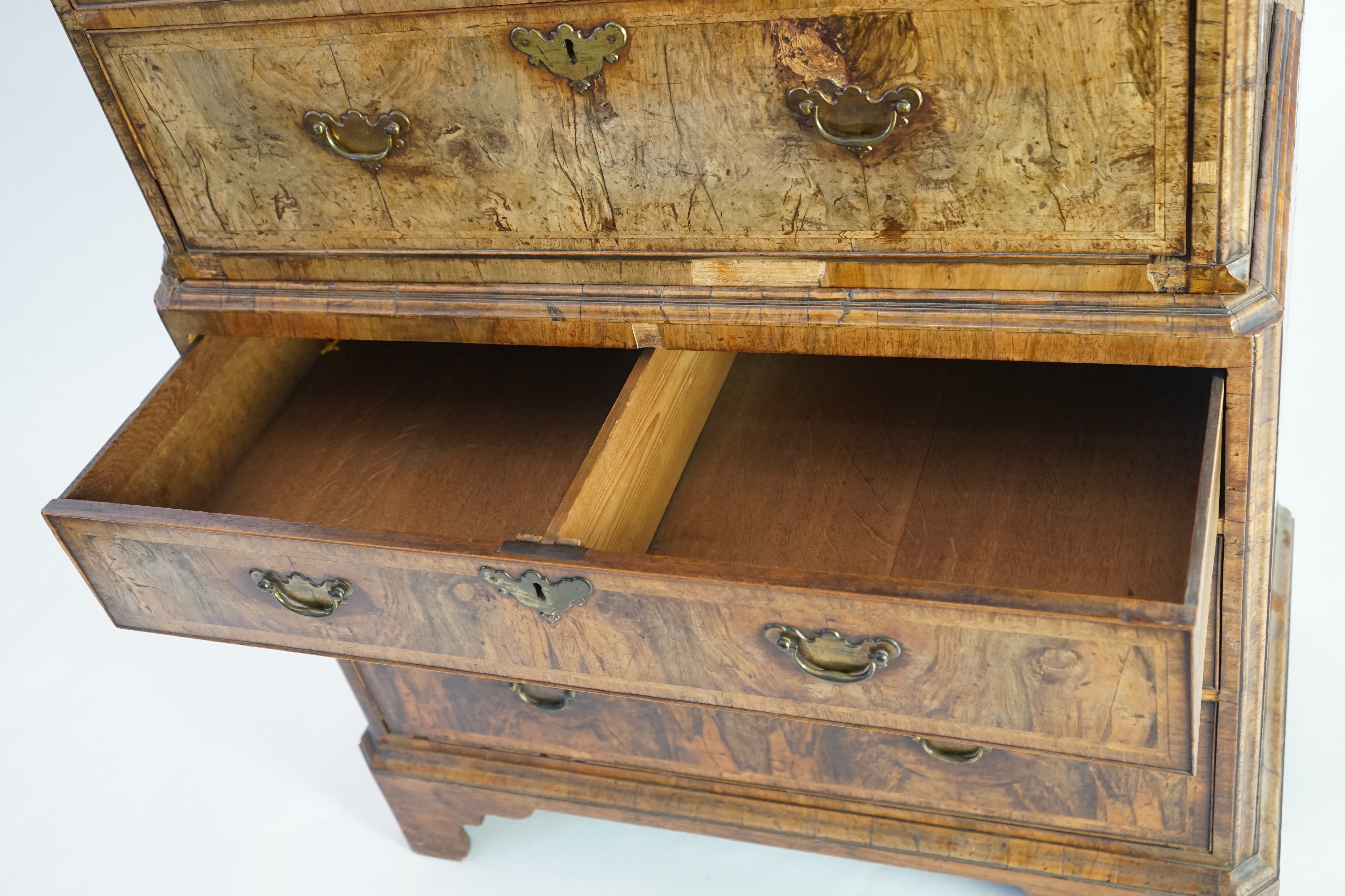 A George II feather banded walnut chest on chest